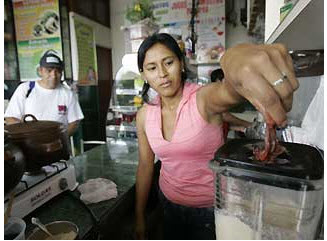 Woman blending a frog smoothie.