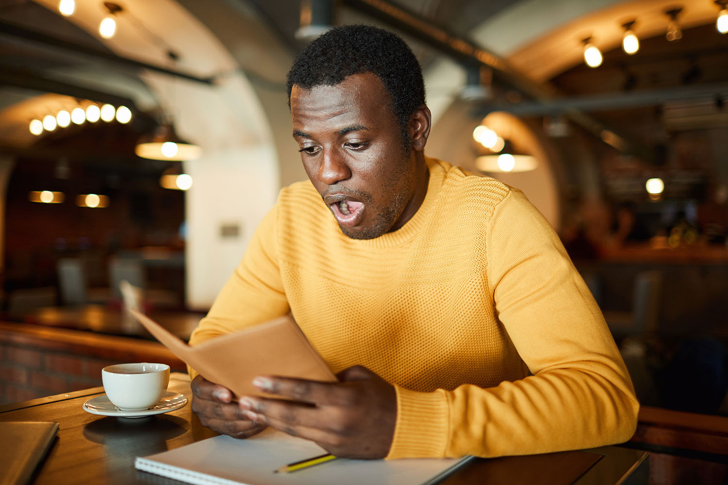 African American man shocked at an expensive food bill.