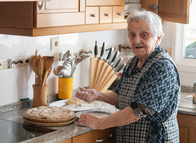 Elderly Woman Cooking in the Kitchen.