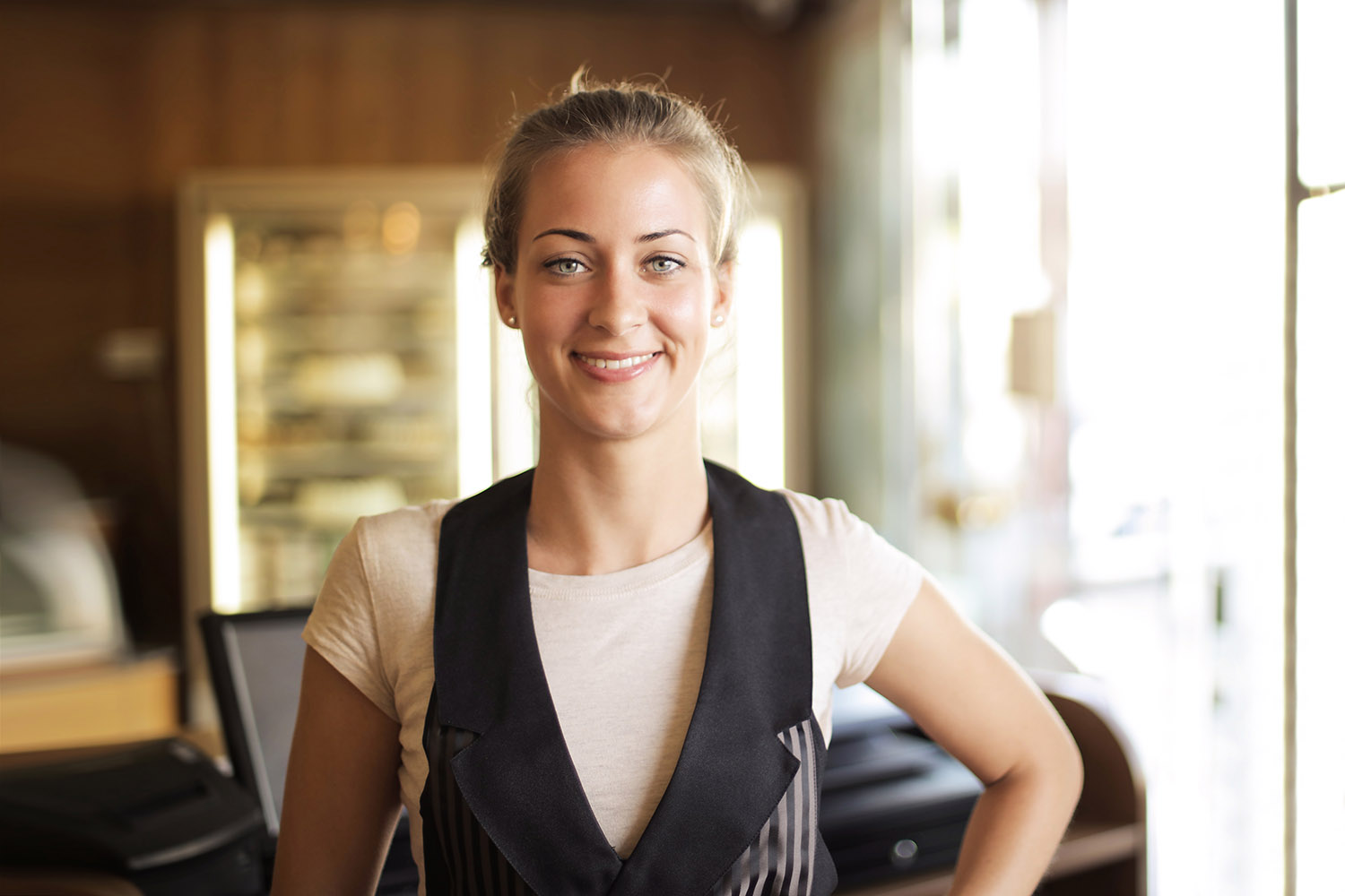 Young waitress smiling for the camera.