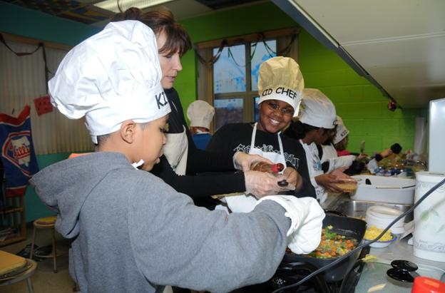 Kid helping in a commercial kitchen.